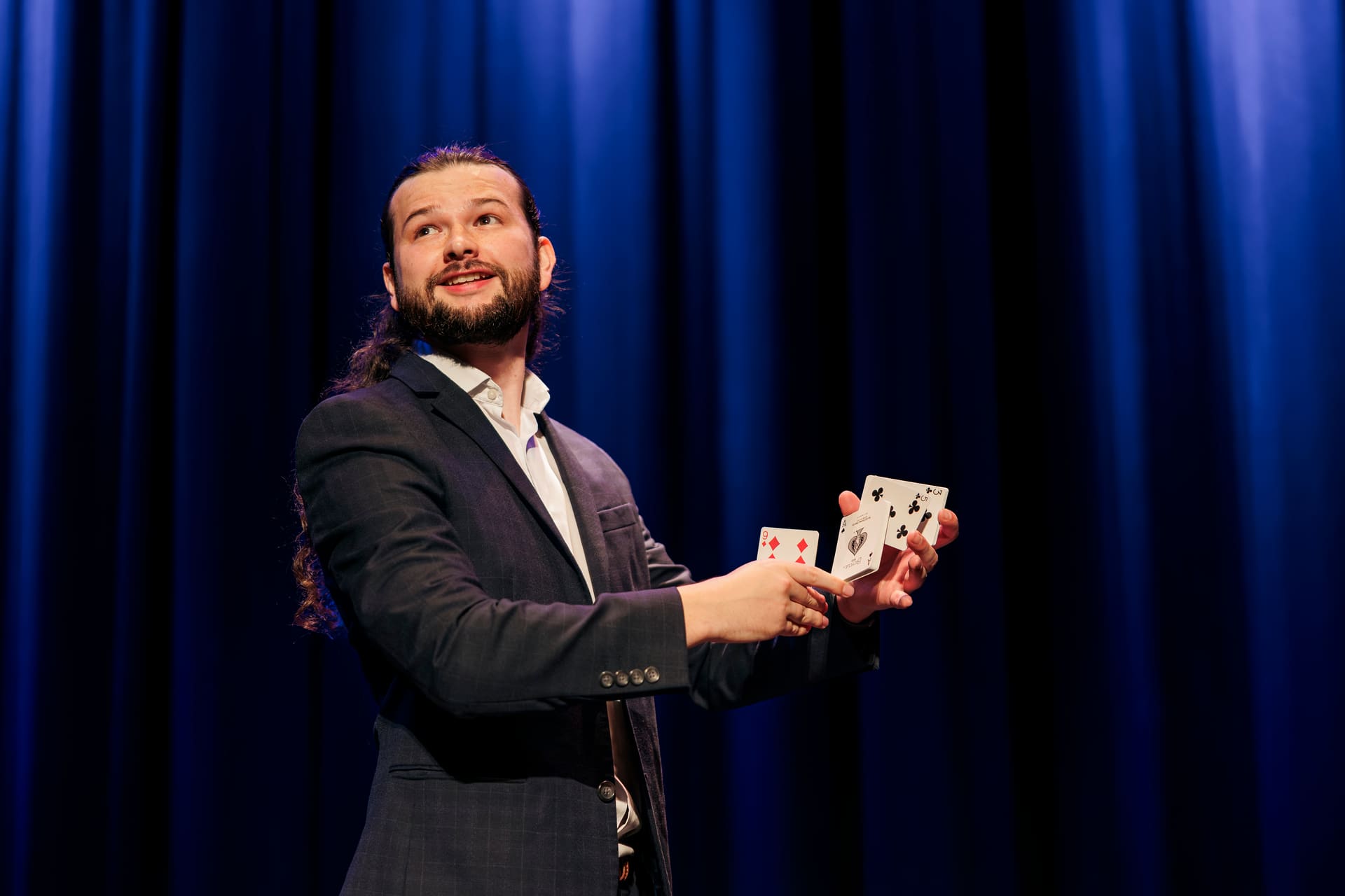 Callum McClure performing a sleight-of-hand card move at close quarters